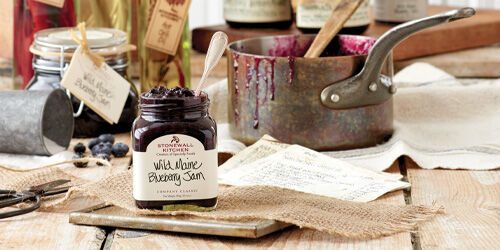 Our Wild Maine Blueberry jam recipe next to a cooking pot 
